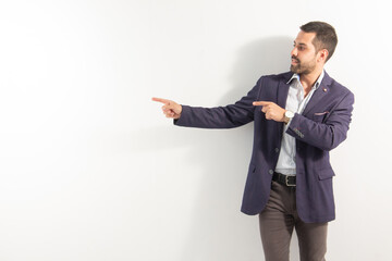 executive guy smiling pointing his two hands to an empty advertising space on a white background