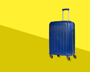 Blue Plastic Trolley  Travel Case with Metal Handle over yellow stylish background