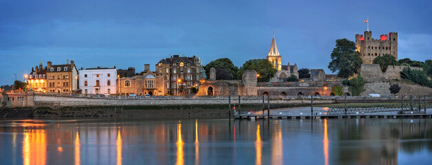 Panoramic view across river to historical Rochester at dusk.