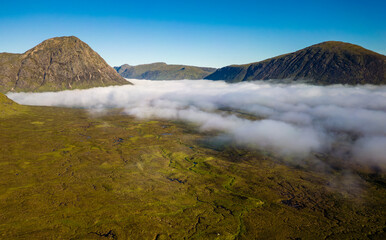 Aerial view of low cloud and fog in a valley just after dawn (Glencoe, Scottish Highlands)