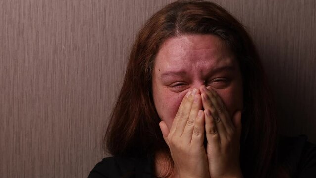 Distressed woman bitterly cry covering swollen face with hands near room wall. Tears roll down cheeks, tearful eyes. Splash out emotions, sob violently. Emotional breakdown, sufferings, Generative AI