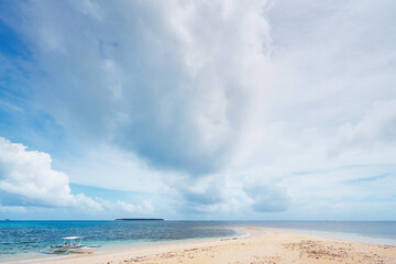 Beautiful landscape with tropical white sand beach with fishing boat. Siargao Island, Philippines.