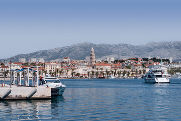 Fototapeta na wymiar Travel by Croatia. Beautiful landscape with Split Old Town on sea promenade. Yacht in the harbour.