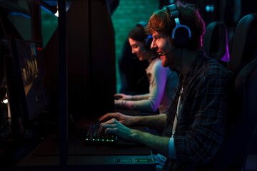 Team of gamers playing video game in cybersport club