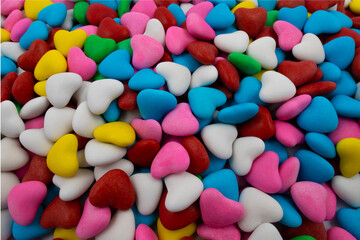 Fototapeta na wymiar Background of multi-colored candies in the form of hearts (close-up)