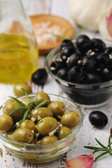 Black and green olives in glass bowls