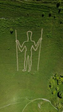 aerial view of a green valley and a figure on it