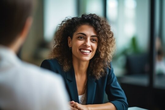 Candid photo of young Hispanic woman meeting with colleague in modern office, collaborating on projects, generative ai