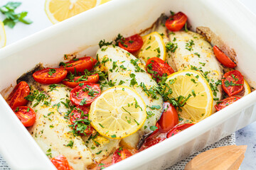 Baked cod fillet with cherry tomatoes and butter.