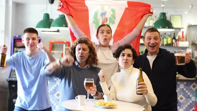 Company of emotional adult young sports fans holding flag of Peru, rejoicing winning match game and drinking beer in bar Generative AI