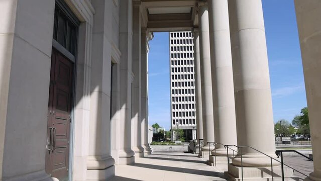 Columns at the Mississippi state Supreme Court building in Jackson, Mississippi with video tilting down.