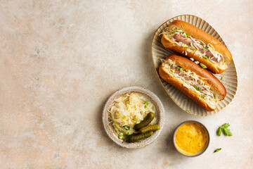 Traditional grilled beef hot dogs with sauerkraut and mustard sauce.