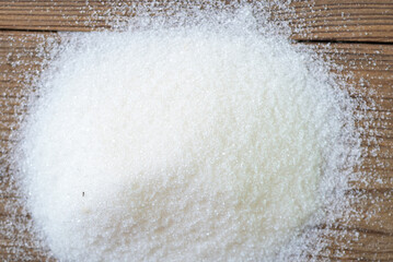 heap of sugar on wooden background, white sugar for food and sweets dessert candy heap of sweet sugar crystalline granulated