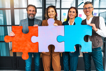 Teamwork of partners connect puzzle pieces as integration and startup