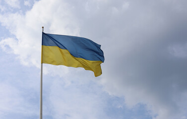 Ukrainian flag on blue sky. Country flag against sky. Flags of the world. Peace in the world. Peaceful flag.