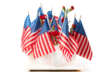 USA flags in vases with red carnations