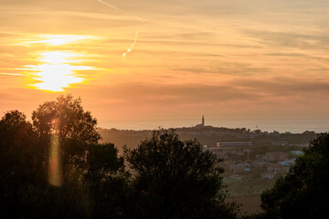 Obraz premium View from the ruins of the castle Kula Trnina to the town Rovij in Istria at sunset in the back light