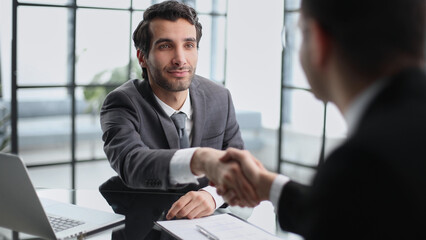 Employer, boss hiring candidate after successful job interview.