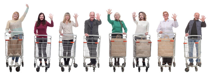 group of people with shopping cart showing thumbs up at camera