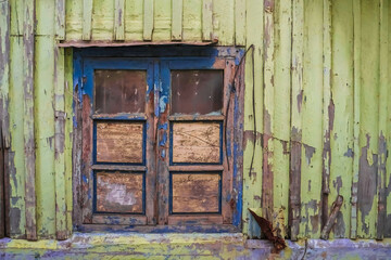 Closed Old wooden window with shutters on an wooden wall. Window on indonesian malay traditional house. Sumatran traditional house. Empty Blank Text Space.
