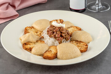 Veal tartare on stone table in fine dining restaurant