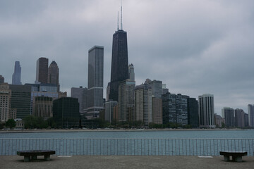 Naklejka premium Skyline of Chicago, Illinois Windy City with skyscrapers and highrises in financial center downtown with Lake Michigan on dramatic clouds on stormy day