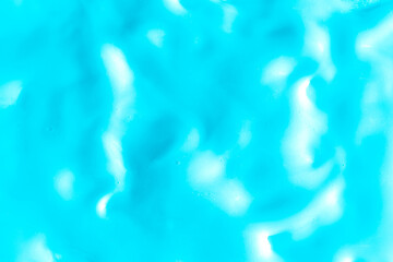 Fototapeta na wymiar Background of light blue cream texture. Berry fruit yogurt or whipped cream. Smooth surface of body lacquer cream. Slime turquoise.