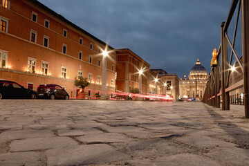 Rome at night, old stone road leading to St Peter's Square with traffic trails (long exposure)