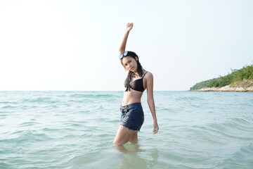 Teenage girl having fun on sea beach,Summer vacation,Sunny hot summer day at tropical ocean beach.