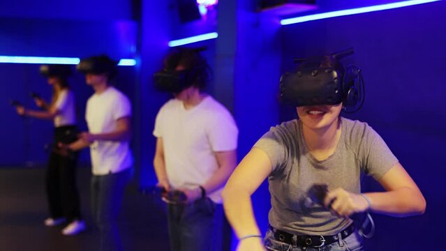 Portrait of happy excited young girl with VR glasses on head, holding handheld controllers playing virtual reality game with friends Generative AI