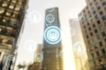 Double exposure of abstract virtual social network icons on modern skyscrapers background. Marketing and promotion concept