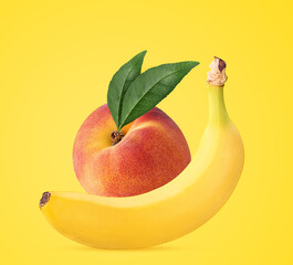 Banana and ripe peach with green leaf