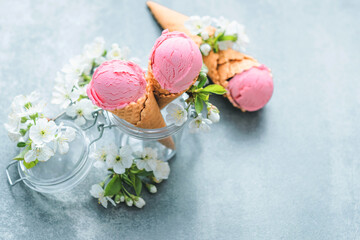 Creamy strawberry ice cream in a glass jar decorated with bloom. Spring inspiration. Healthy summer...