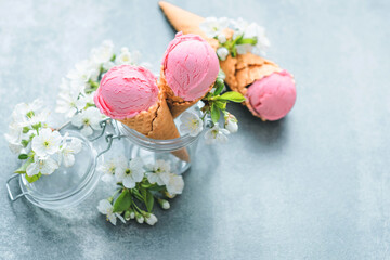 Creamy strawberry ice cream in a glass jar decorated with bloom. Spring inspiration. Healthy summer dessert. top view