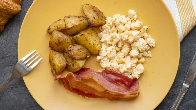 Rotating Plate of Scrambled Eggs, Potatoes and Bacon