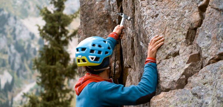 Man is climbing, hiking in the mountains.