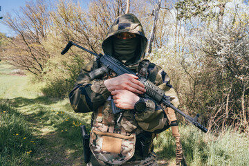 Soldier in a trench. Member of the International Legion patrols. The war in Ukraine.Army soldier Patrolled the front line, Soldier with assault rifle. 