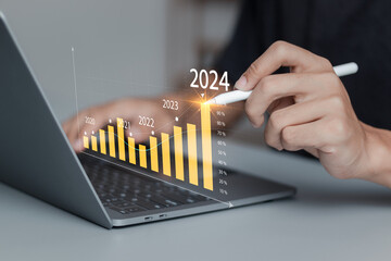 New year business goals 2024 and positive indicators 2024. Businessman analyzing economic trend data for long-term investment.