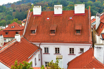 View of the old white houses with a red tiled roof. Ancient buildings in the village. Cityscape. Prague, Czech Republic, October 2022.