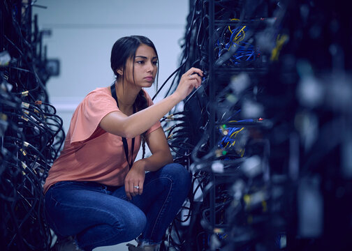 Female technician working in server room