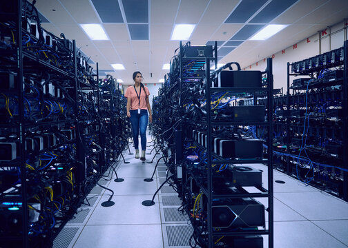 Female technician working in server room