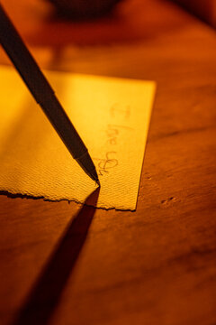 Close-up of pen writing on linen notecard