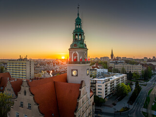 Olsztyn - the town hall decorated with white and red flags at sunrise