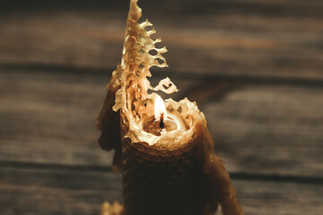 A candle made of natural wax is half burnt.
