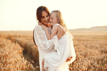 Mother with daughter playing in a summer field