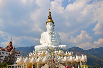 A large golden Buddha statue set in an outdoor area