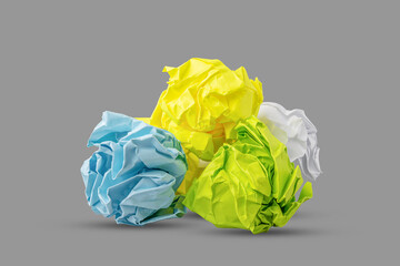 Crumpled multicolored paper isolated on gray background. Paper crumpled into a ball. Recycling, ecology, business.