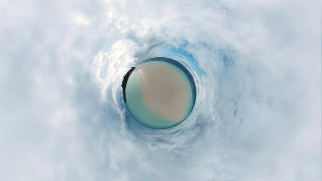 Little Tiny Planet 360 Degree Footage of a sandbank on a paradise island at the Maldives on a cloudy day with flight into the reality