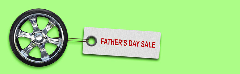 Obraz premium Father's Day sale background. Car wheel and label on a bright green background.Business. Trade. Holidays.
