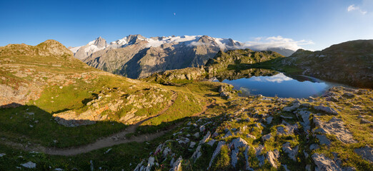 Emparis Plateau and Lerie Lake with view on the Ecrins National Park and the La Meije peak in the Alps. GR 54 hiking trail in the Oisans Massif. Hautes-Alpes, France